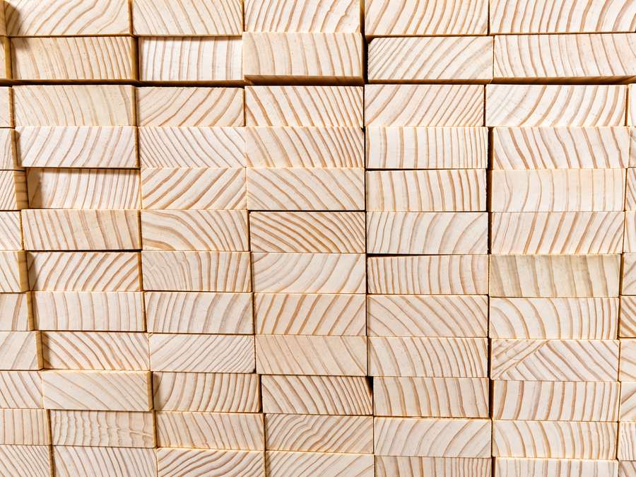 Stacked radiata pine end-grain timber blocks.