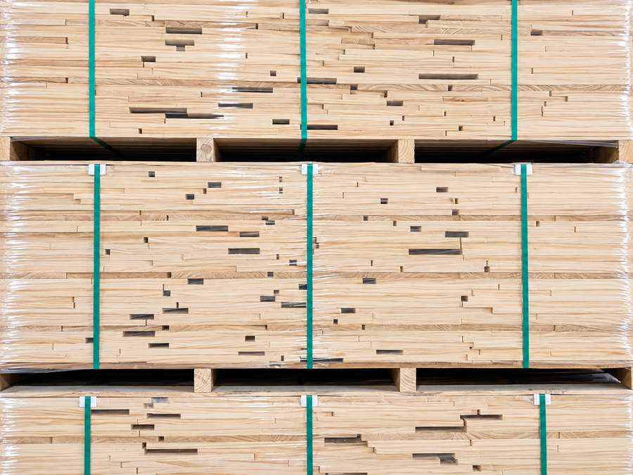 Shrink-wrapped Radiata Pine timber stacks.