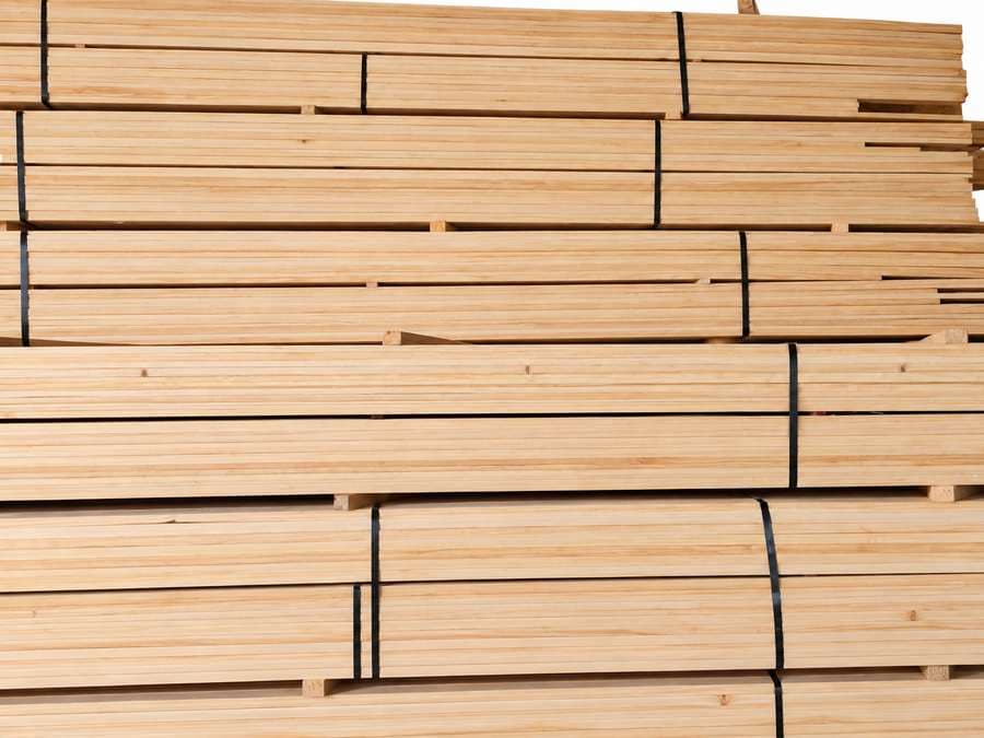 Neatly stacked radiata pine timber boards.