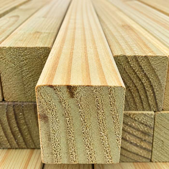 Stacked treated radiata pine timber boards.